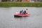 a group of Indonesian people is on inflatable boat without wearing a life jacket at Batukarut Lake or Situ Batukarut Sukabumi,