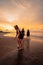 a group of Indonesian women doing ballet movement exercises together very flexibly on the beach