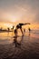 a group of Indonesian women doing gymnastic exercises very agile on the beach