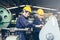 Group of industrial factory maintenance engineers inspect relay protection system using walkie talkie