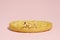 Group of infant toddlers sitting above biscuit baby. Isolated on pink background.