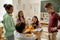 Group of intercultural learners discussing schoolwork during lunch break