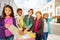 Group of international kids standing with luggage