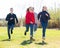 Group of joyful teenagers running down in the park