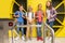 Group of joyous children standing near the turnstile indoors