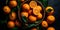 Group of juicy oranges arranged in a wooden crate, set against a dark background with a top-down view.