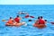 Group of kayaks are swimming by the sea. Kayaking background