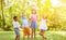 Group of kids cheering and dancing in summer