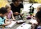 Group of kids classmates learning biology drawing class