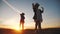 group of kids dancing in the park silhouette at sunset. kid dream party concept. children dancing in nature at sunset