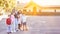 Group of kids in elementary school with teacher on schoolyard