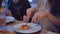 Group kids family of people eat pizza at a cafe indoors. close-up children teens eating fast food in cafe slow motion