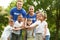 Group of kids joining hands with volunteers