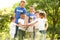 Group of kids joining hands with volunteers