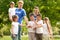 Group of kids joining hands with volunteers