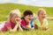 Group of kids lying on blanket or cover outdoors