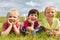 Group of kids lying on blanket or cover outdoors