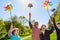 Group of kids is playing with colorful windmills