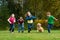 A group of kids racing on grass