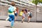 Group of kids run to school one after another