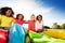 Group of kids sit with race sacks on the lawn