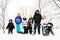 Group of kids in the snow with sleds