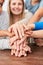 Group of kids stacks hands for cooperation