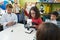 Group of kids students using microscope repairing gadget at laboratory classroom