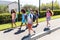 Group of kids wearing face masks walking on footpath