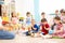 Group of kindergarten children play with musical toys. Early musical education in daycare