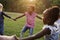 Group of kindergarten kids friends holding hands playing at park