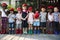 Group of kindergarten kids friends holding magnifying glass for