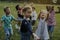 Group of kindergarten kids friends playing blowing bubbles fun