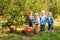 Group of kindergarten kids helping to pick apples