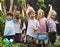 Group of kindergarten kids learning gardening outdoors