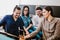 Group of latin business people working together as a teamwork while sitting at the office desk in a creative office in Mexico city