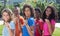 Group of laughing brazilian young adults pointing at camera