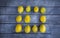 A group of lemons arranged in a square pattern of twelve with one missing