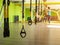 Group lesson with a trainer and training on the TRX sport loop in the new modern fitness complex, copy space, people