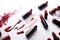 a group of lipsticks that are laying on a white surface with a red stain on the surface of the lipstick and the lipsticks are