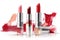 a group of lipsticks with a splash of red paint on the background of the image and a white background with a white background