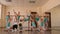 A group of little ballerinas relax in the ballet Studio near the ballet barre.