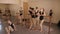 A group of little ballerinas relax in the ballet Studio near the ballet barre.