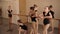 Group little ballerinas are watching adult ballerinas dancing ballet.