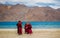 Group of Little buddhist monks wearing Covid mask near beautiful Pangong lake