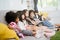 Group of little children watching film movie cartoon together on digital tablet. Kids playing with tablet with friends at home.