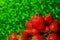 group of little strawberry soft focus with romantic green glitter bokeh background