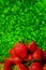 Group of little strawberry soft focus with romantic green glitter bokeh background