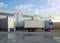 Group of logistic trailer trucks or lorries at warehouse