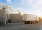 Group of logistic trailer trucks or lorries at warehouse